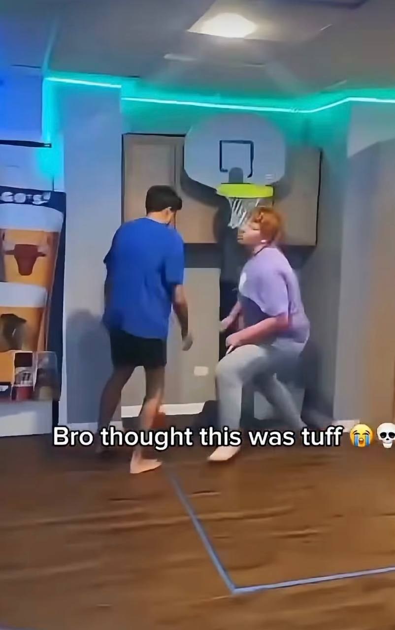 The shooter posting up under the small wall-mounted hoop