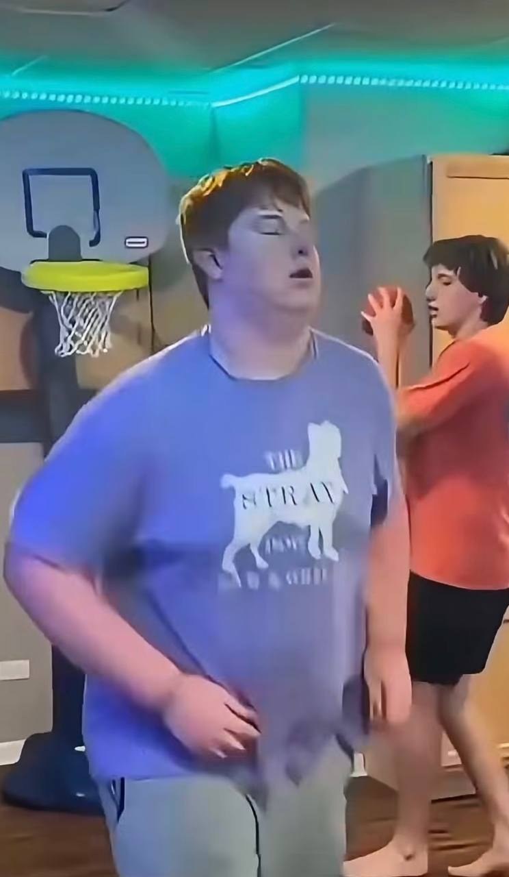 The shooter in his Stray Dog t-shirt walking past the wall hoop